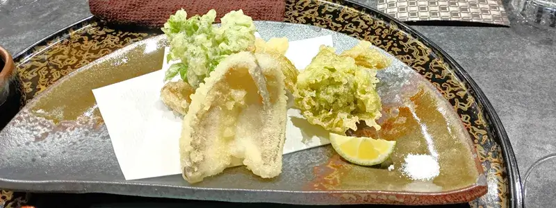 四代目魚盛の天ぷら。キスと山菜の盛り合わせでサクサクの食感が楽しめる一皿